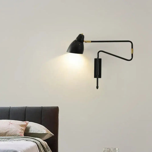 Modern black and brass wall light with articulated arms and backplate width designed for bedroom or studio use with e26 bulb base