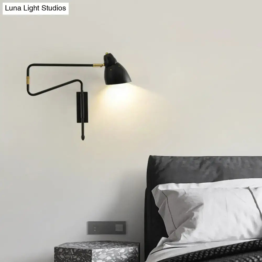 Modern black and brass wall light with articulated arm and backplate width suitable for bedroom or studio bulb base