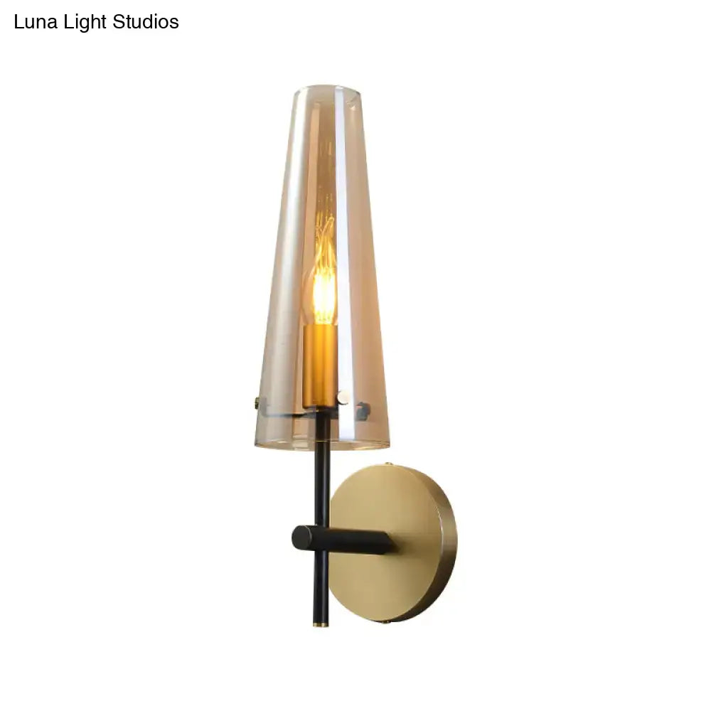 Modern black and brass wall mount light with smoked glass shade and gold-toned mounting plate for study room wall light