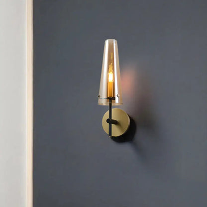 Modern black and brass wall mount light with translucent amber glass shade ideal wall light for study room
