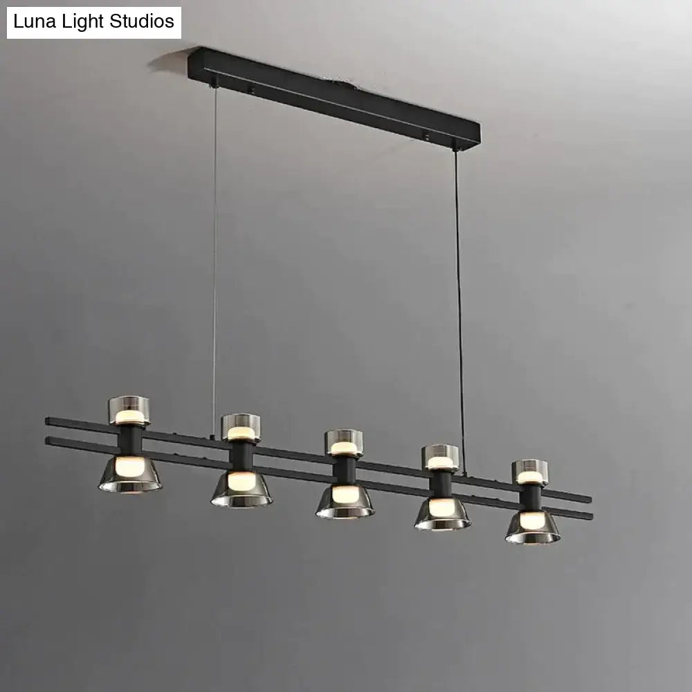 Modern black and chrome linear led strip lamp with five cylindrical metal fixtures for kitchen island lighting