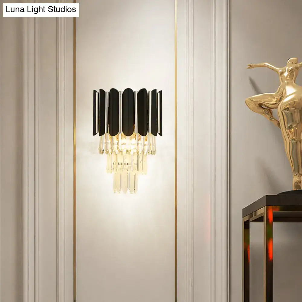 Modern black and gold wall sconce with clear crystal accents for bedroom tiered lighting fixture