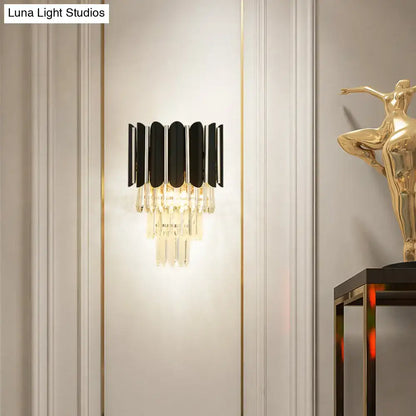 Modern black and gold wall sconce with clear crystal accents for bedroom tiered lighting fixture