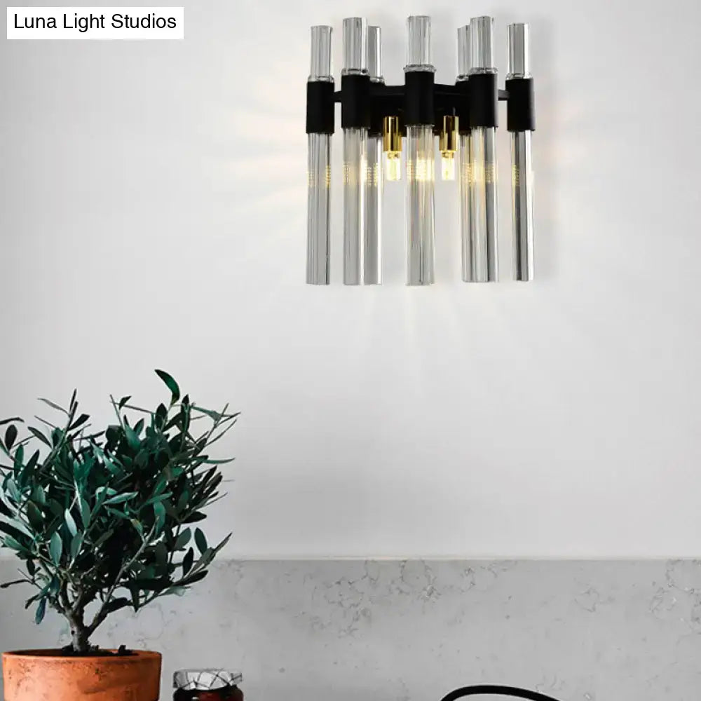 Modern black wall lamp with clear glass tubes and gold-toned bulbs for stylish living room lighting