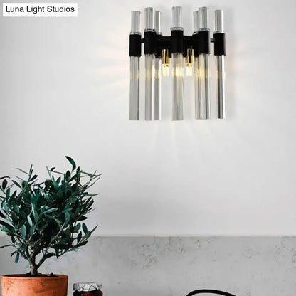 Modern black wall lamp with clear glass tubes and gold-toned bulbs for stylish living room lighting