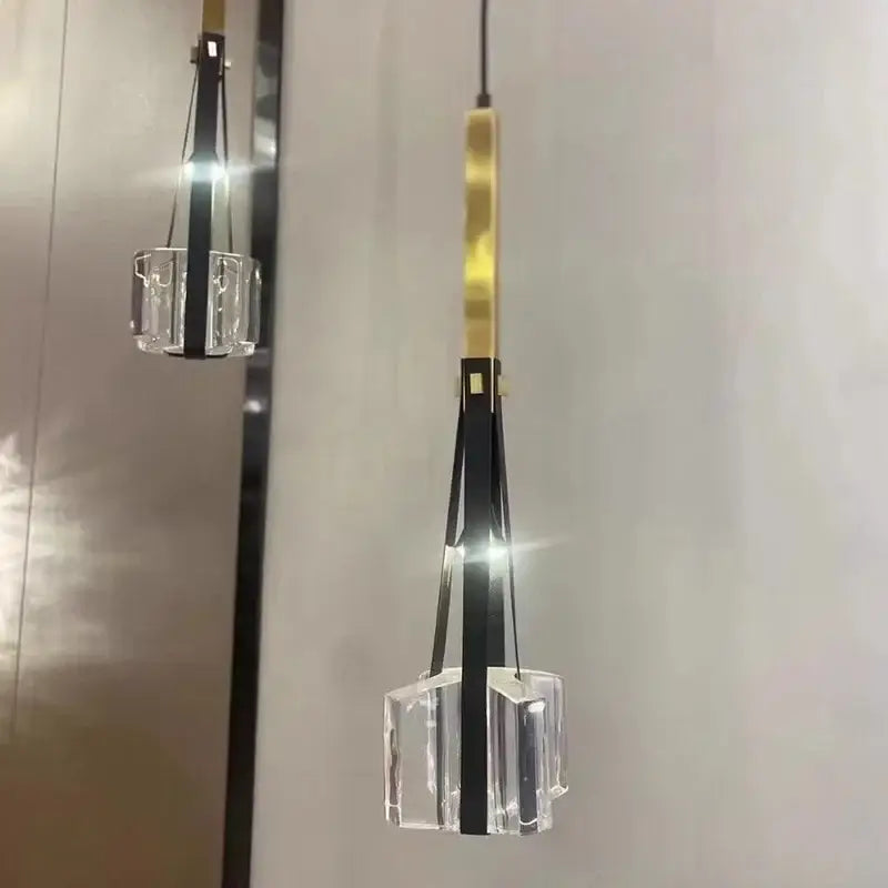 Modern black and clear white resin pendant light with a geometric crystal cube base and gold-toned rod for kitchen use