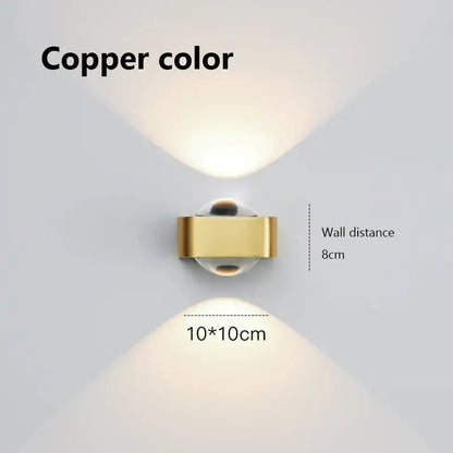 Modern black and copper bedroom wall lamp featuring a copper bedroom wall spotlight with a sleek rectangular metallic body and glass dome lens
