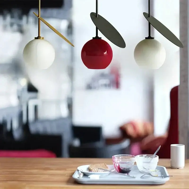 Three modern pendant lights with white and red glass cherry shades and gold-toned arms for dining room decorbites glass cherry