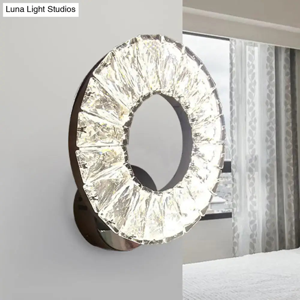 Modern black and crystal chrome wall sconce with sleek metal frame and faceted crystals highlighting fixture height