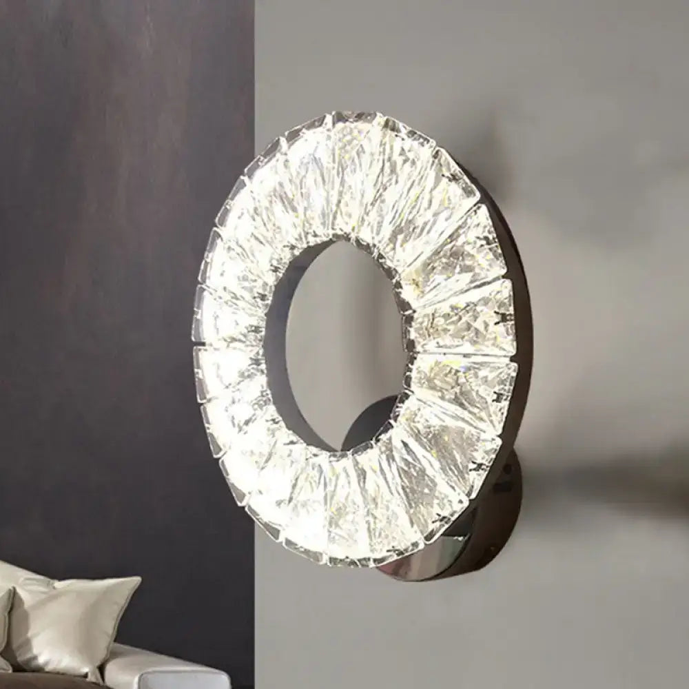 Modern black and crystal chrome wall sconce with faceted clear elements illuminating color temperature in bedroom light