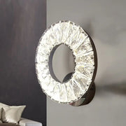 Modern black and crystal chrome wall sconce with faceted clear elements illuminating color temperature in bedroom light
