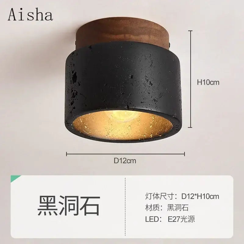 Modern black and gold cave stone ceiling chandelier with rustic wooden top and warm golden interior glow decorbites cave stone