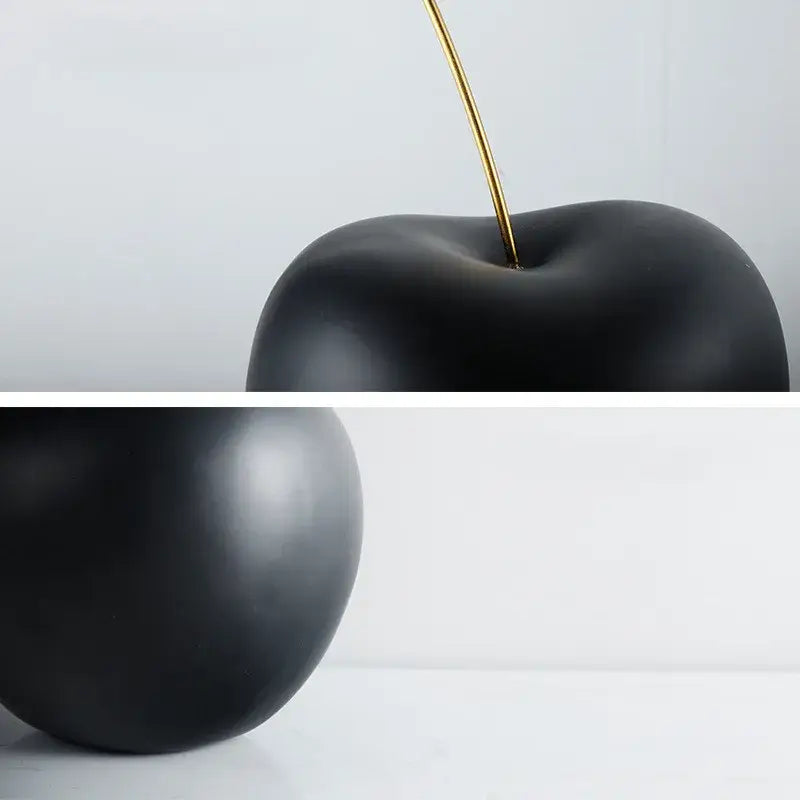 Modern black and gold cherry resin sculpture with a glossy black cherry and slender gold stem for living room decorbites decor