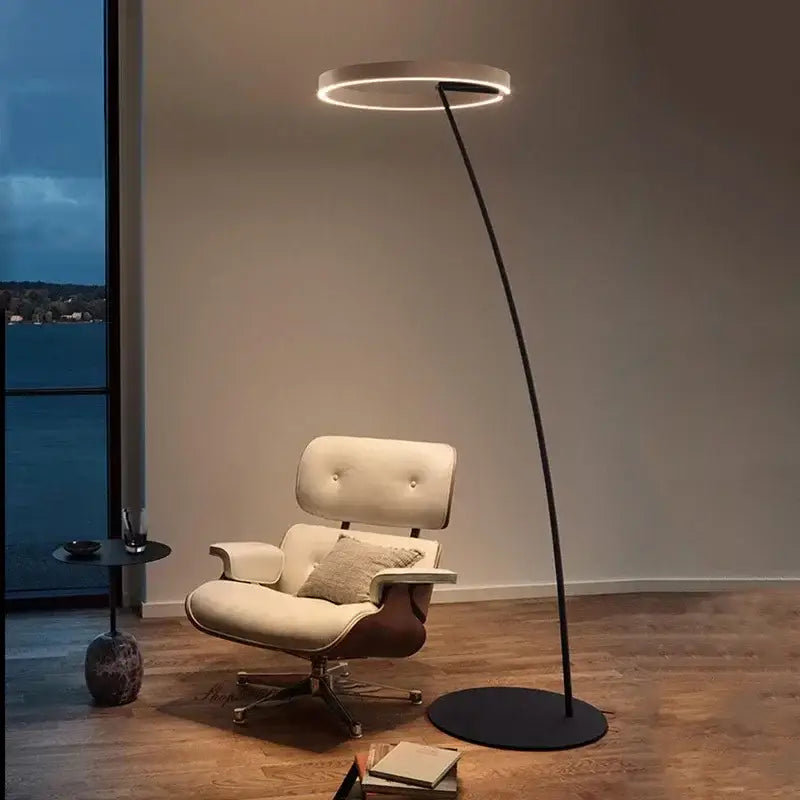 Modern black and gold decorbites circular luminescence led floor lamp with sleek curved stand emitting warm ambient light