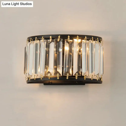 Elegant modern black and gold crystal wall lamp featuring vertical crystal prisms and gold-toned accents for bedrooms