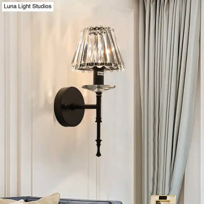Elegant black wrought iron wall light with cascading crystal shade and gold accents featuring e12 bulb base and fixture height design