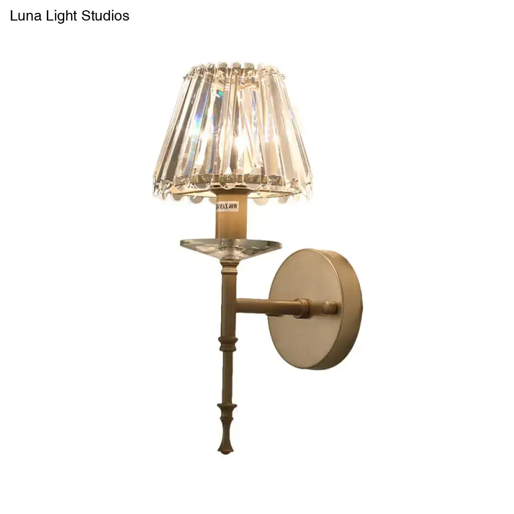 Elegant modern black and gold wall light with brass fixture height and e12 bulb base featuring a faceted crystal shade
