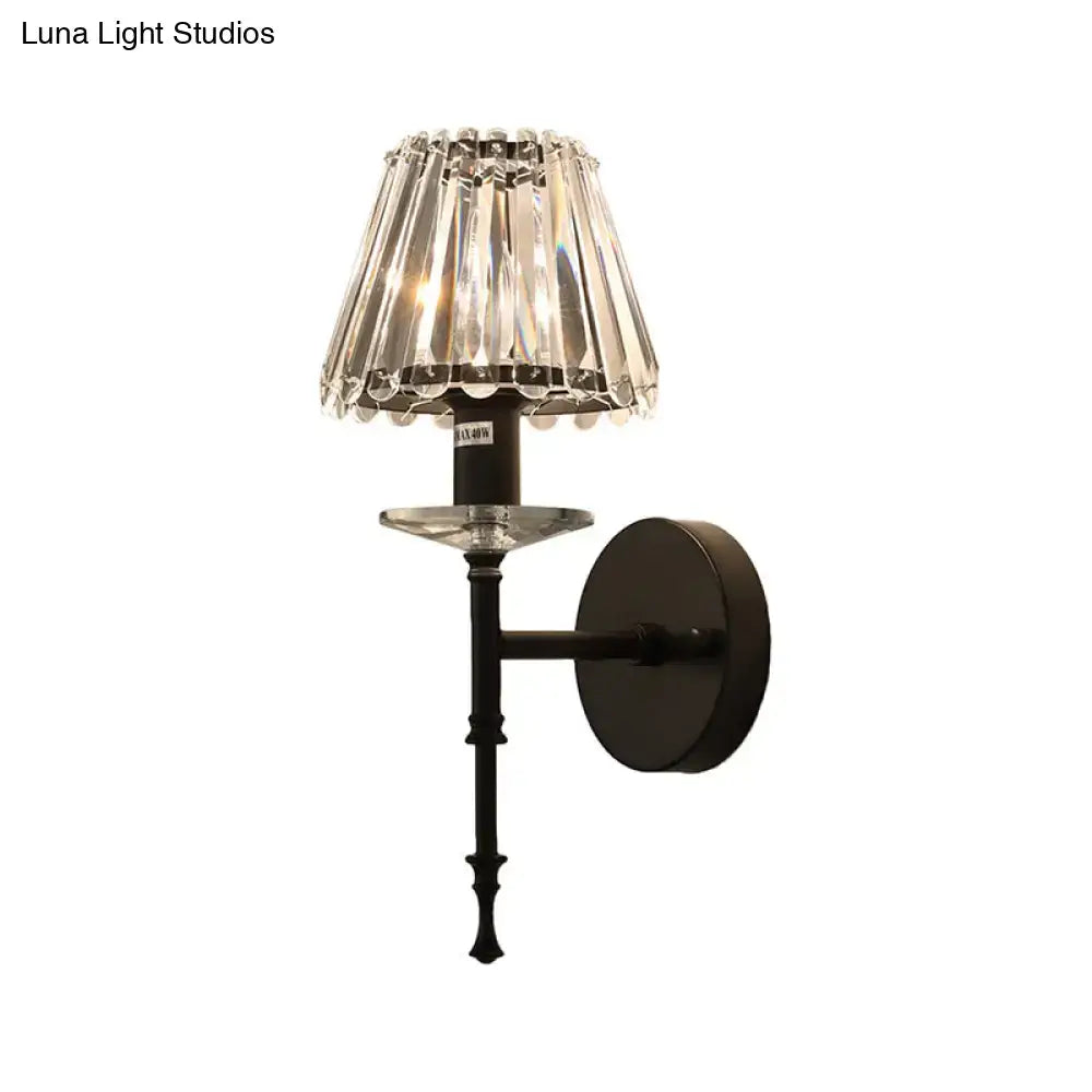 Elegant black metal wall light fixture with cascading crystal shade featuring e12 bulb fitting and modern design