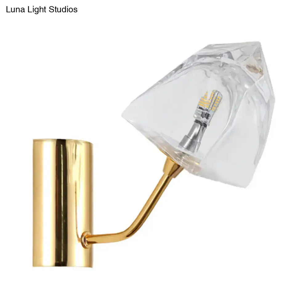 Modern black and gold faceted glass wall sconce with polished gold bulb base and clear crystal shade fixture height and backplate width visible
