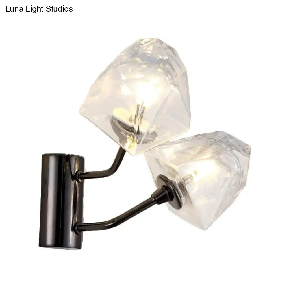 Modern black and gold faceted glass wall sconce with clear crystal shades on a black metal arm and base showing fixture height and backplate width
