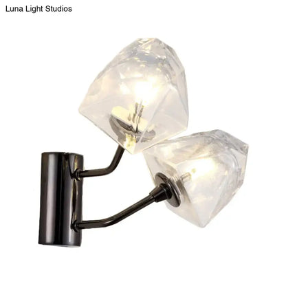 Modern black and gold faceted glass wall sconce with clear crystal shades on a black metal arm and base showing fixture height and backplate width