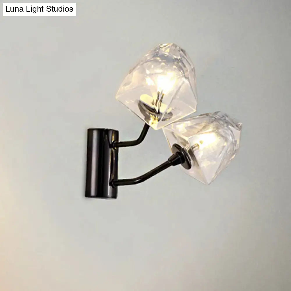 Modern black metal wall sconce with two faceted crystal shades featuring bulb base and backplate width details