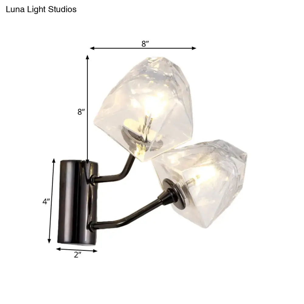 Modern black metal wall sconce with two clear faceted crystal shades features bulb base and compact backplate width