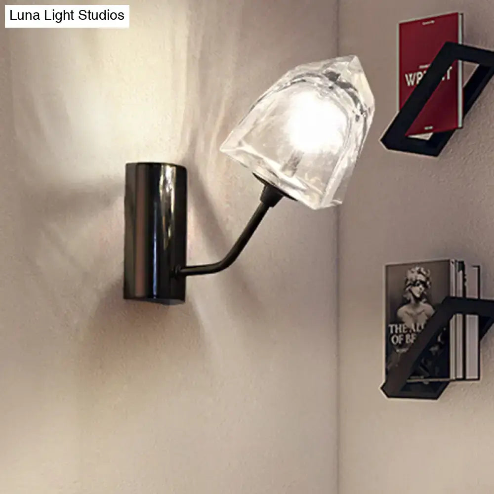 Modern black metal wall sconce with faceted clear glass shade featuring bulb base, fixture height, and backplate width details
