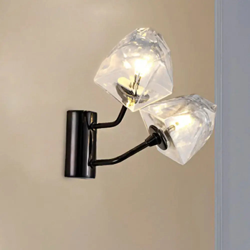 Modern black metal wall sconce with two faceted crystal shades featuring bulb base and backplate width details