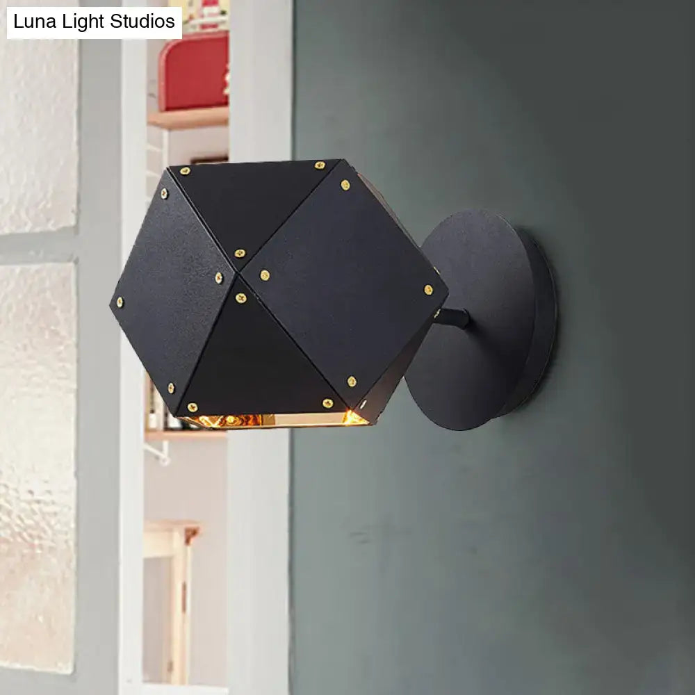 Modern black and gold geometric wall light with gold-toned rivets and warm glow ideal for dining room sconce lighting