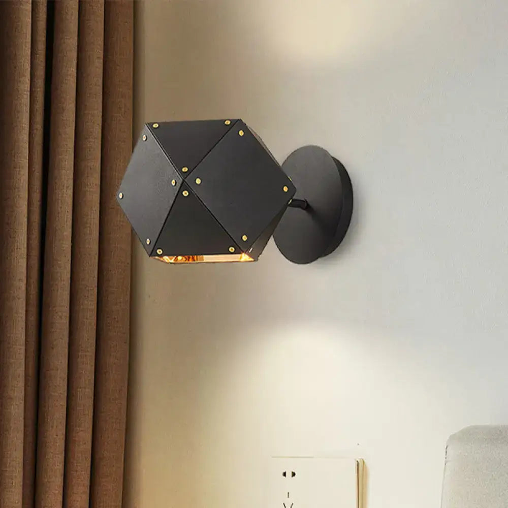 Modern black and gold geometric wall light with gold rivets and warm glow for dining room sconce lighting