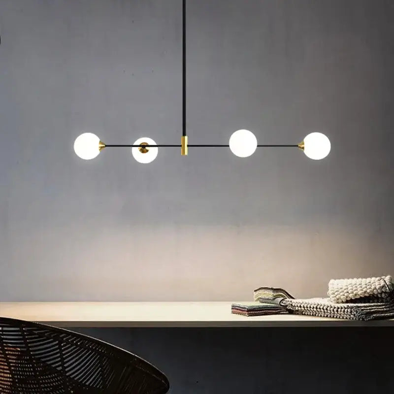 Modern black and gold glass ball pendant chandelier with four frosted glass globe bulbs and sleek metal frame decorbites glass ball