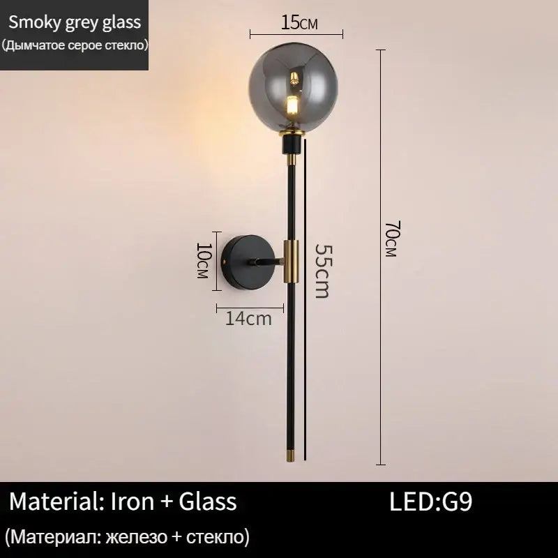 A modern black and gold glass ball wall lamp with smoky grey glass globe and iron rod for living room decorbites decor
