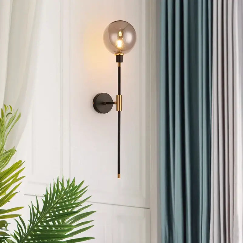 Modern black and gold glass ball wall lamp with smoked glass globe and metal stem for living room decorbites wall lamp