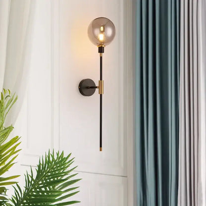 Modern black and gold glass ball wall lamp with smoked glass globe and metal stem for living room decorbites wall lamp