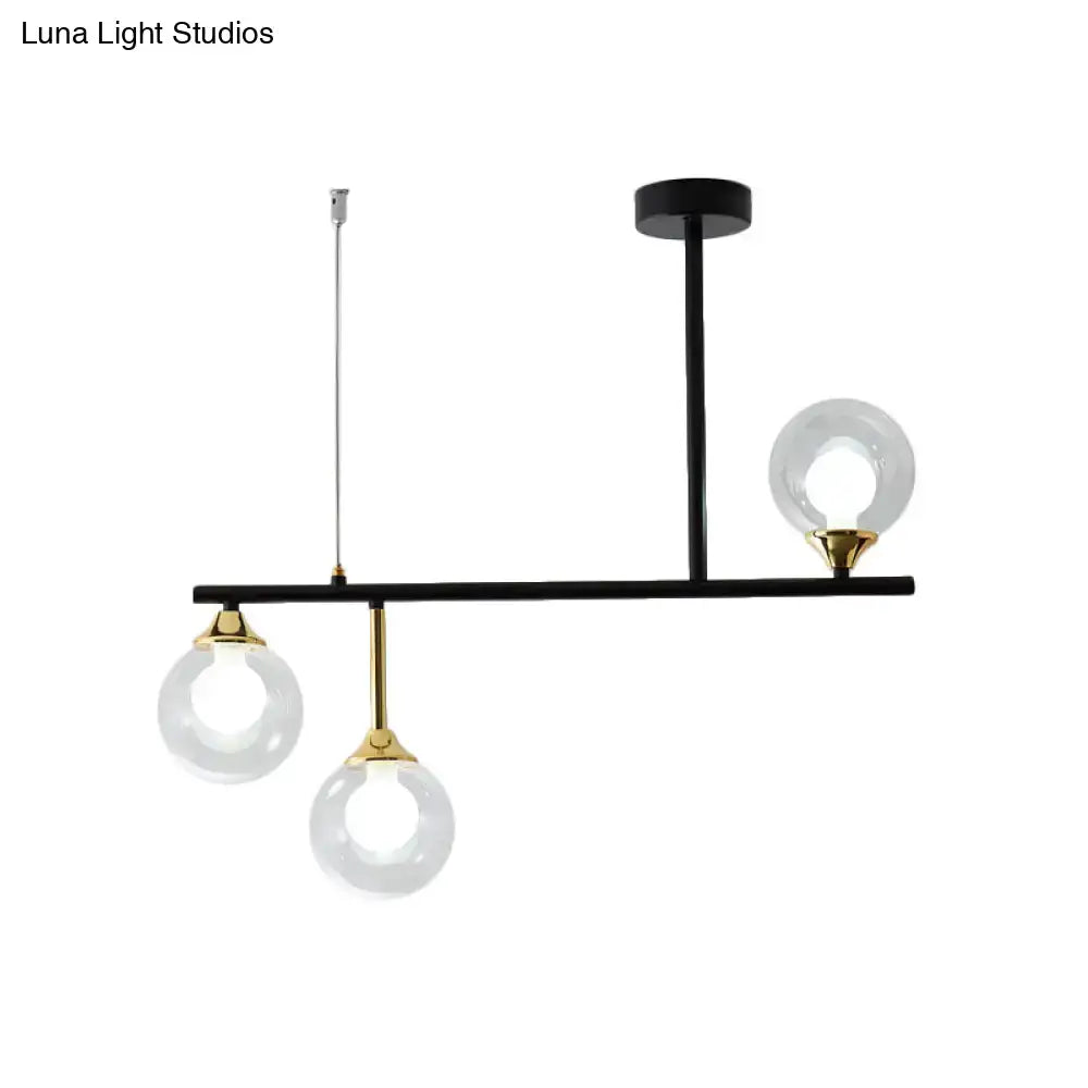 Modern black and gold pendant light fixture with three clear glass globes for dining room pendant light decor