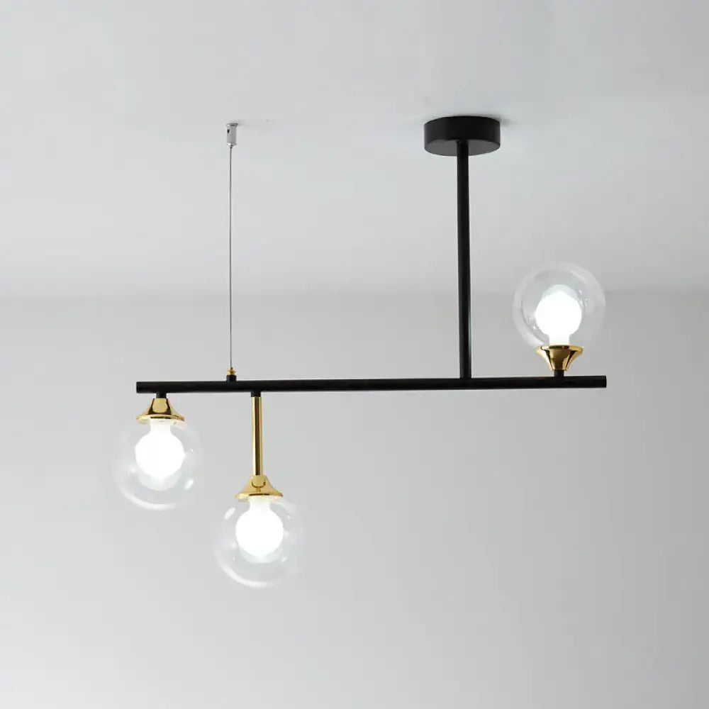 Modern black and gold globe pendant light with three clear glass bulbs in black metal fixture for dining room pendant light fixture