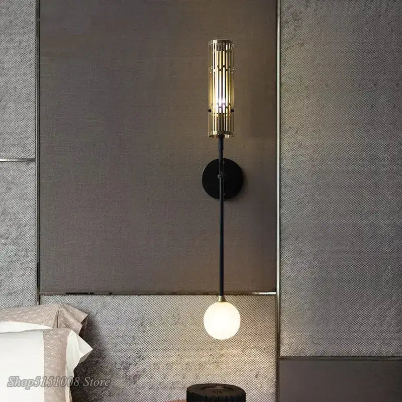 Modern black and gold led wall lamp with metal base and gold-toned slat shade featuring a glowing white bulb for decorbites led wall