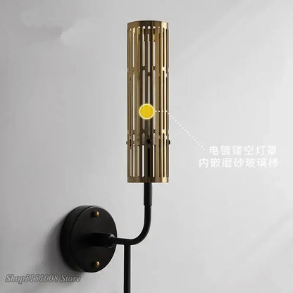 Modern black and gold led wall lamp with gold-toned cylindrical slats and black mounting base for living room decorbites led wall