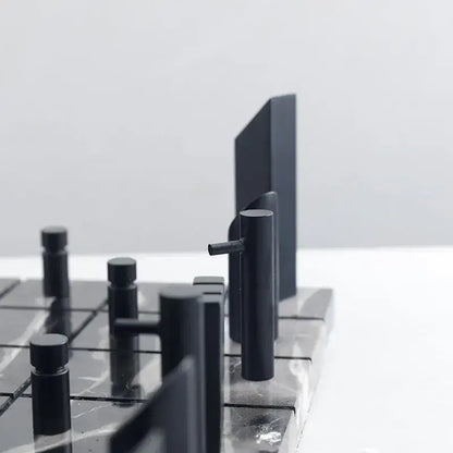Modern black and gold metal marble chessboard with sleek matte pieces on a polished marble board for decorbites golden metal decorbites golden metal