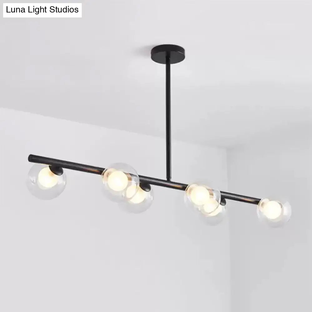 Black metal DecorBites chandelier with five clear glass globe shades featuring modern light bulbs for dining table use