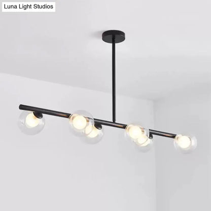Black metal DecorBites chandelier with five clear glass globe shades featuring modern light bulbs for dining table use