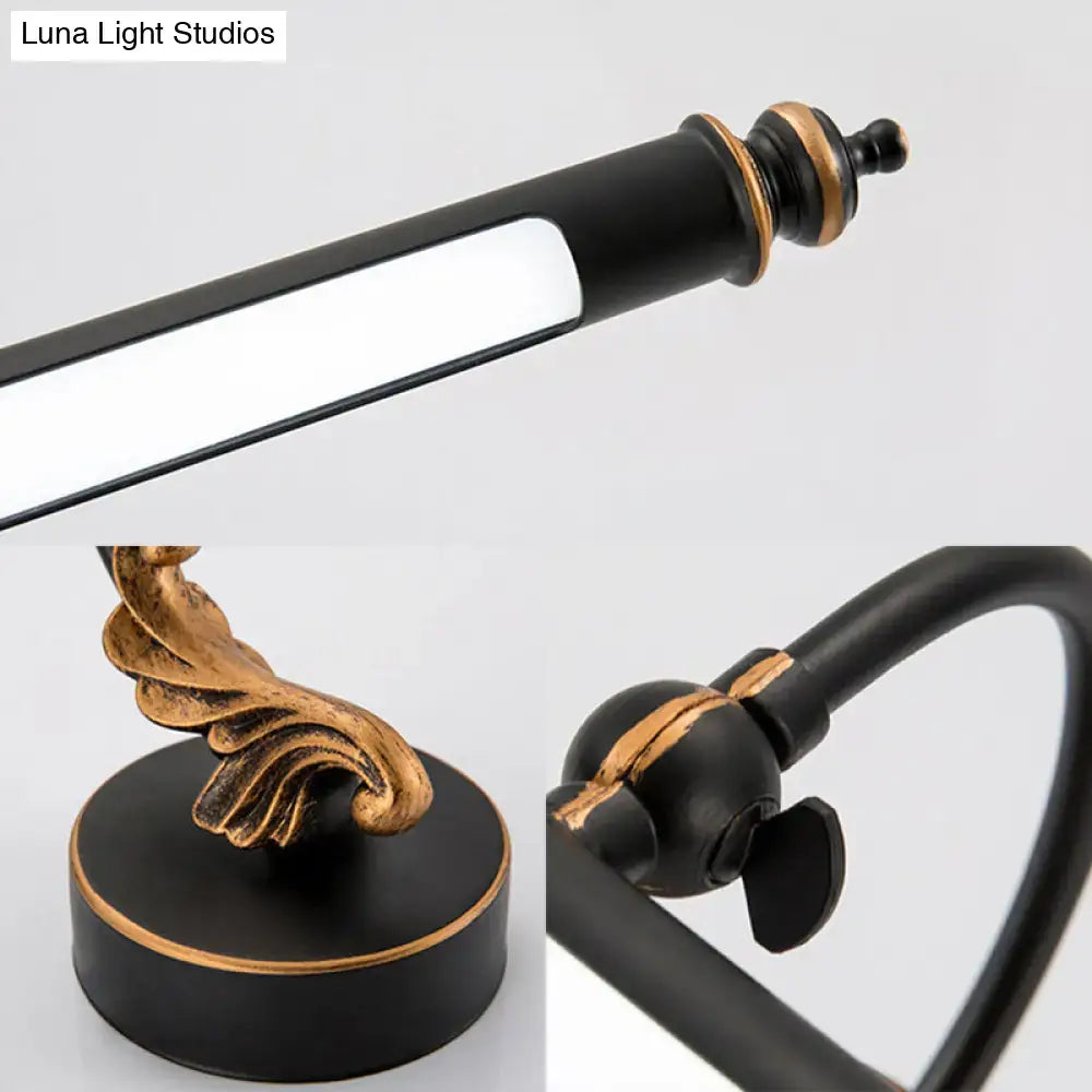 Modern black and gold ornate bathroom towel rack with adjustable arm paired with tubular led wall light sconce