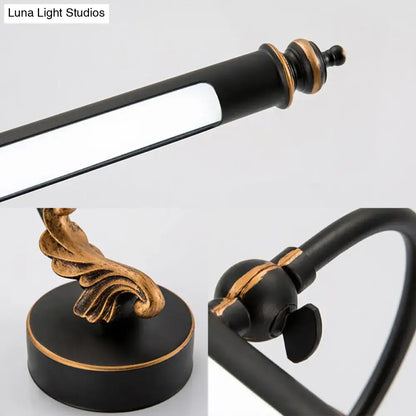 Modern black and gold ornate bathroom towel rack with adjustable arm paired with tubular led wall light sconce