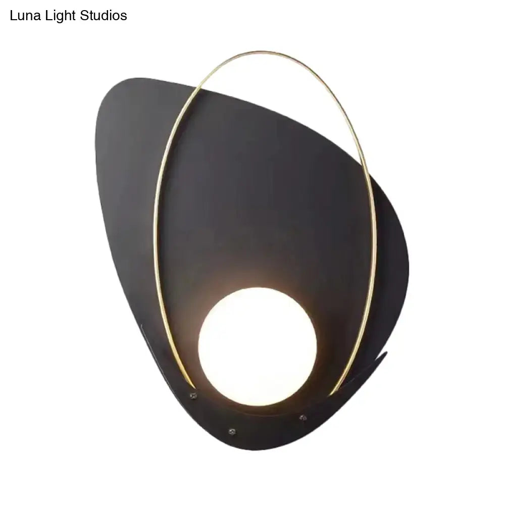 Modern black and gold wall lamp with a sleek abstract shape and white glass shade bedroom sconce with gold frame
