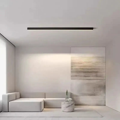 Minimalist white sectional sofa with soft upholstery beneath modern black and metallic decorbites led ceiling light