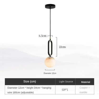 Modern black pendant light with polished copper finish and warm amber marble globe shade for dining room use
