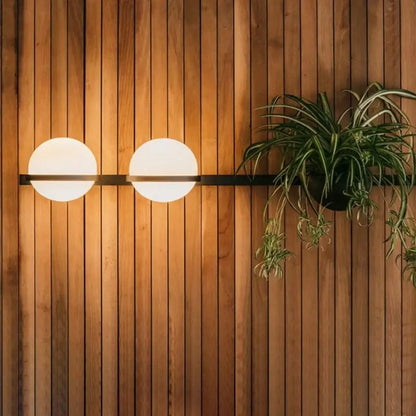 Modern black and white acrylic ball wall lights featuring two frosted white acrylic globes on a minimalist black bar