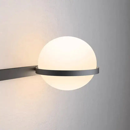 Modern black metal wall lights with a frosted white acrylic ball globe for bedroom sconces