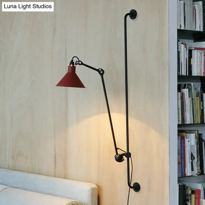 A modern black and white articulated bedroom wall lamp with a red conical shade direct wired electric fixture